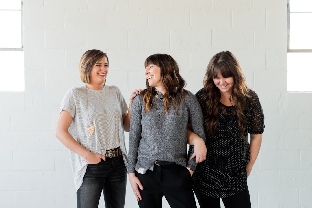 Work colleagues share a laugh about the stresses of their work in Logan, Utah. Kulor Salon in Logan Utah is the best option for a luxury salon experience.